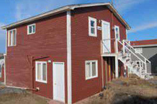 Our Waterfront Building is located next door to the Red Bay Interpretation Centre (grey building at right). Image